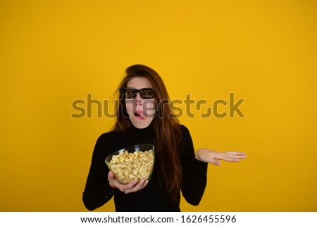 emotional woman with popcorn in hands watching movie isolated background