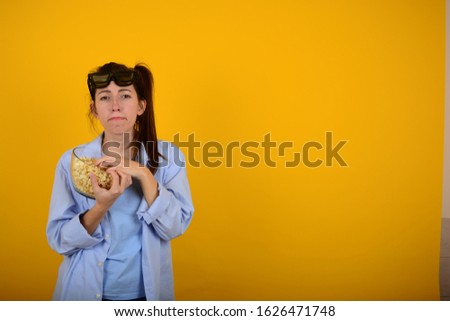 young woman with popcorn on an isolated background place free