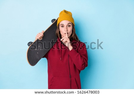 young skater caucasian woman isolated keeping a secret or asking for silence.