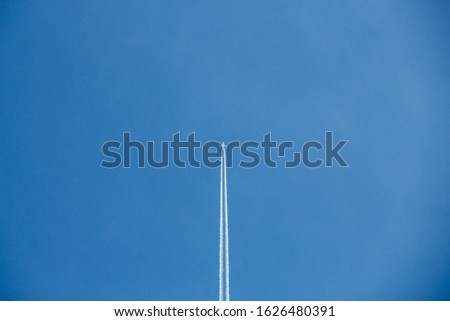 Simplistic airplane trail picture blue sky
