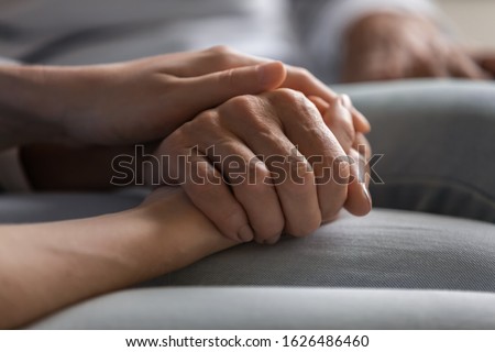 Close up young woman holding hand of elderly lady, having heart-to-heart sincere trustful conversation. Compassionate grown up daughter supporting older mother, overcoming problems together. Royalty-Free Stock Photo #1626486460