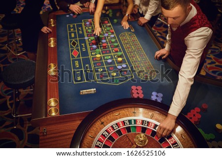 People gambling at roulette poker in a casino.