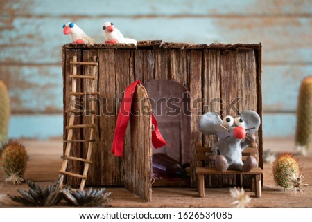 Rats from plasticine and model houses built from wood chips.Cartoon style mouse.Shabby house modeled out of Wood.The concept of drought and poverty in 2020.
