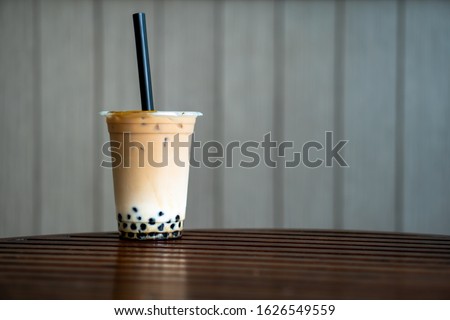 A glass of takeaway bubble milk tea with blurred background with space for word or textures Royalty-Free Stock Photo #1626549559