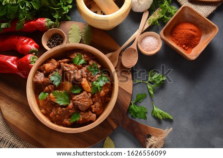 Goulash traditional Hungarian Beef Meat Stew or Soup with vegetables and tomato sauce, Comfort winter or autumn foods concept Royalty-Free Stock Photo #1626556099