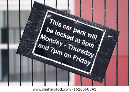 Car park close open times sign on entrance