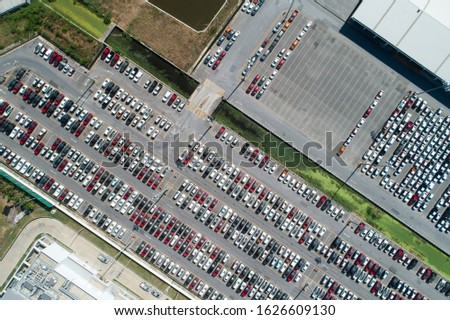 Aerial view of huge parking area in front of building