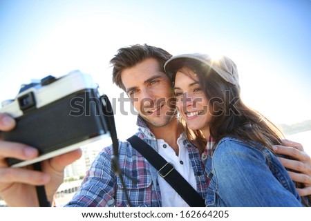 Cheerful couple taking picture of themselves