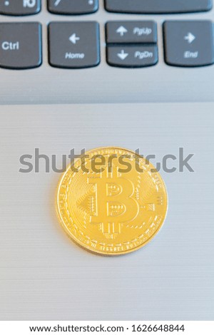 Bitcoin on a laptop. Bitcoin coin symbol on laptop, future concept financial currency, crypto currency sign. vertical photo