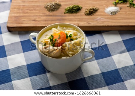 Chicken Noodle Soup. Classic American Restaurant or Diner favorite. Homemade soup with chicken broth, noodles celery carrots seasoned with salt and pepper and garnished with Italian parsley. 