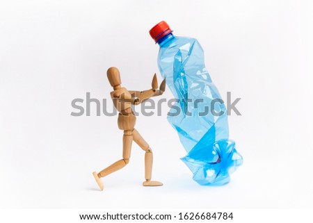 Creative artwork of mannequin stop or prohibition using plastic bottles on white background urging people not to use the item to prevent marine pollution