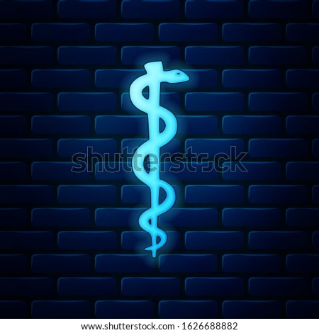 Glowing neon Rod of asclepius snake coiled up silhouette icon isolated on brick wall background. Emblem for drugstore or medicine, pharmacy snake symbol