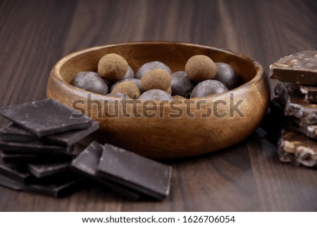 Different kinds of chocolate stock images. Chocolate sweets stock images. Pile of Chocolate stock images. Assorted chocolate candies isolated on a wooden background