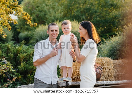 Happy family with their son walking in the Park at sunset. Happiness. Love