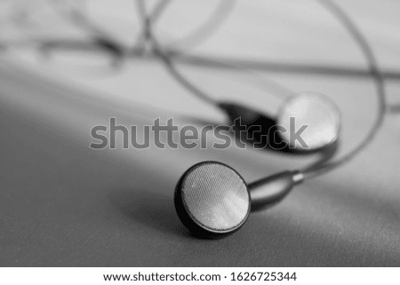 Black and white close up shot of an earphone.
