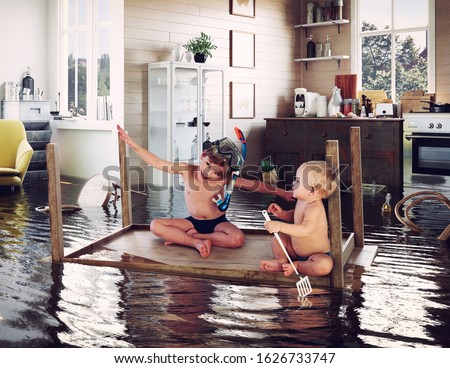 kids pday on the table while flooding in the kitchen. Photo and media photocombination Royalty-Free Stock Photo #1626733747