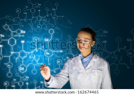 Young woman researcher in medical uniform drawing chemistry formulas Royalty-Free Stock Photo #162674465