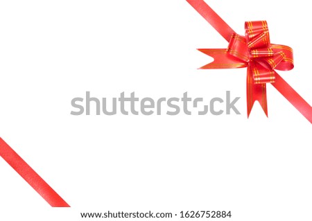 a red gift bow with yellow stripes and a red ribbon in the upper right corner of the image on a white background