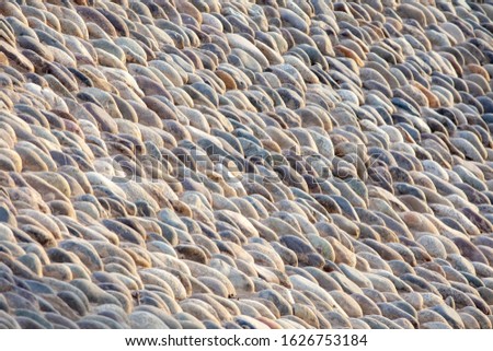 Wall of sea stones, background. Neatly laid out fence. Background, copy paste.