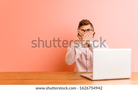 Young man working in a call center doing a denial gesture