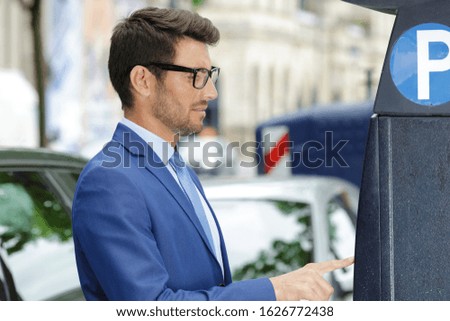 a businessman pays for parking