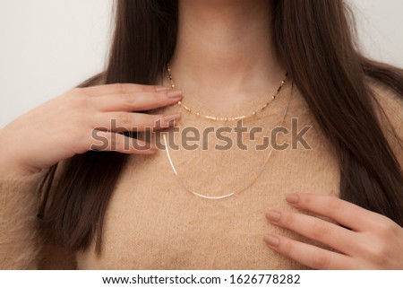 Necklace photographed on model in stylish dress.