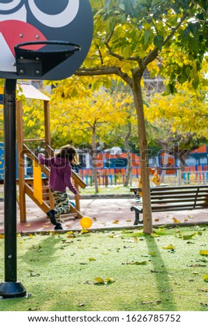Little girl playing in the village park