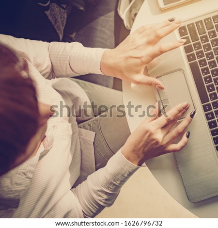 Top view photo of young businesswoman working on laptop