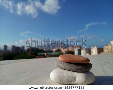 photo of stones on the background of a blue sky waiting for the summer