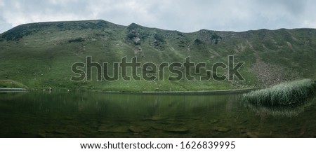 Panoramic view on quiet mountain lake high in Carpathians