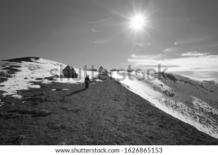 Italy, Sicily, Catania Province, people walking on the volcano Etna with snow