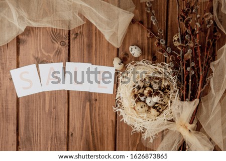 Easter sale message with Easter eggs on a wooden background. Top view.