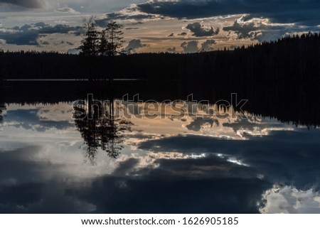 Sunrise over the lake with the reflection in the water, long shutter speed