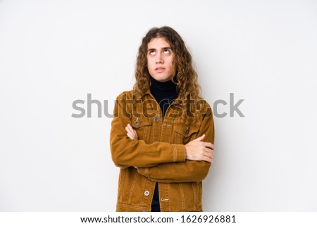 Long hair man posing isolated tired of a repetitive task.