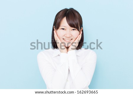happy young girl against blue background 