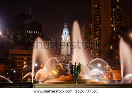Street fountain on Benjamin Franklin parkway at night toward Penn square and city hall of Philadelphia
