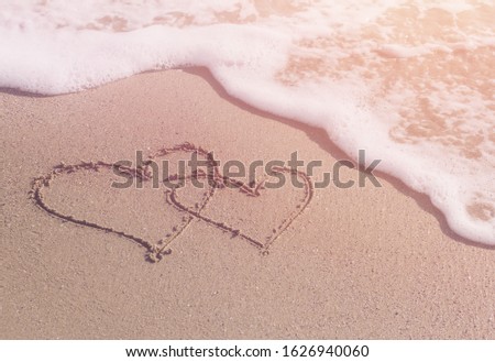 Beautiful heard drawn in the sand on the sea coast. Valentine's Day