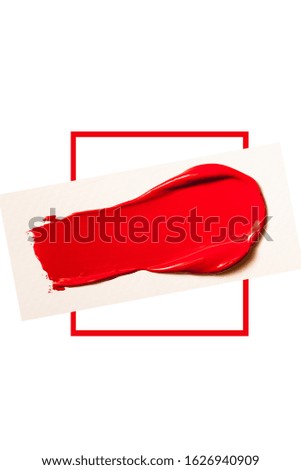 Texture of classic red lipstick on a white background close-up.