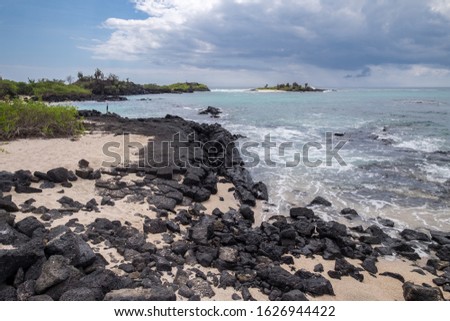 Very nice waves crushing over the rocks on the shore of the beach at Floreanda island, Galapagos, Ecuador