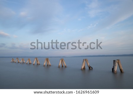 A pier in the sea under the beautiful cloudy sky during daytime