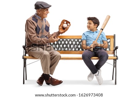 Elderly man with basbeball glove and ball talking to a boy and sitting on a bench isolated on white background