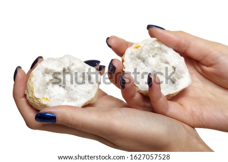 Quartz geode in female hands isolated on white background. Nails with blue manicure. Royalty-Free Stock Photo #1627057528