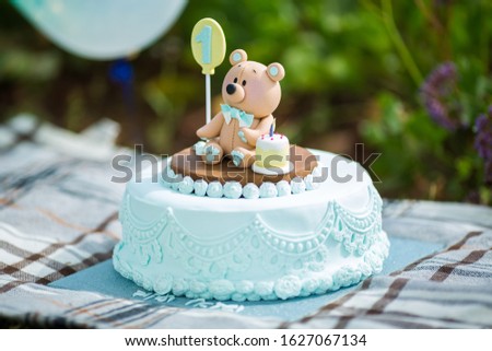 Amazing cake for boy's first Birthday. Blue and white colors with Bear cub from sugar mastic
