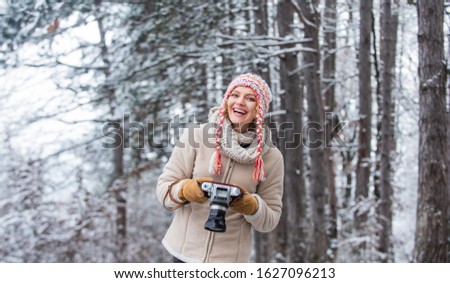 Curious beauty. make photo shot of snowy winter nature. cold and beautiful weather. happy hiker girl retro camera. professional photographer winter landscape. woman hold photo camera.