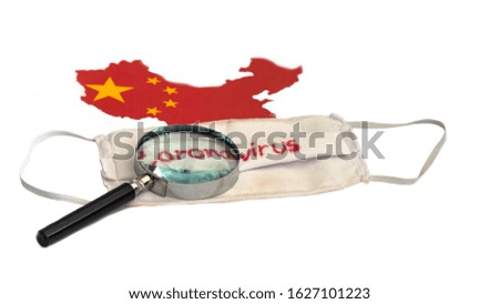 Magnifying glass put on the mask white with a dust stain and have red text "(coronavirus)". All placed on a map of China.   Plague from China Or the corona virus Concept.