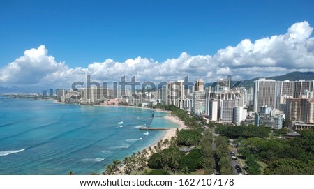 Waikiki Beach photo take from Diamond head showing all the hotels in Waikiki, Honolulu, Oahu, Hawaii and magnificent Waikiki beach in the main picture with so many tourists  and turquoise waters