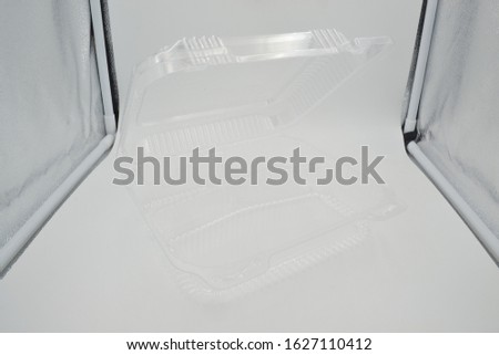 Empty closed disposable transparent plastic bowl isolated on white background.