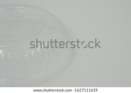 Empty closed disposable transparent plastic bowl isolated on white background.