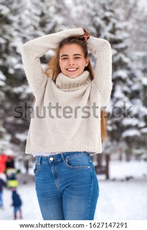 Close up portrait of a young beautiful teenager girl in white sweater