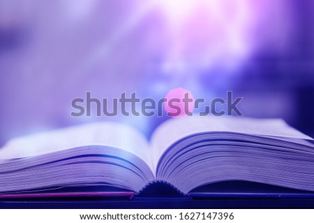 The Book magic lighting with the bright shining down background. Imagine a picture book concept.
knowledge concept learning technology. Education kids books. Book open with a sparkling golden.